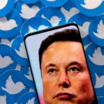 An image of Elon Musk is seen on a smartphone placed on printed Twitter logos in this picture illustration taken April 28, 2022. REUTERS/Dado Ruvic/Illustration